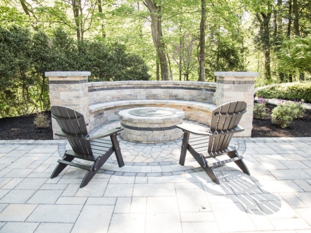 Check out this beautiful stone patio installation project we recently completed. We are one of the top companies in camp hill PA for all things patio. This image also shows a fire pit on the patio with lawn chairs surrounding it, ready for enjoyment.